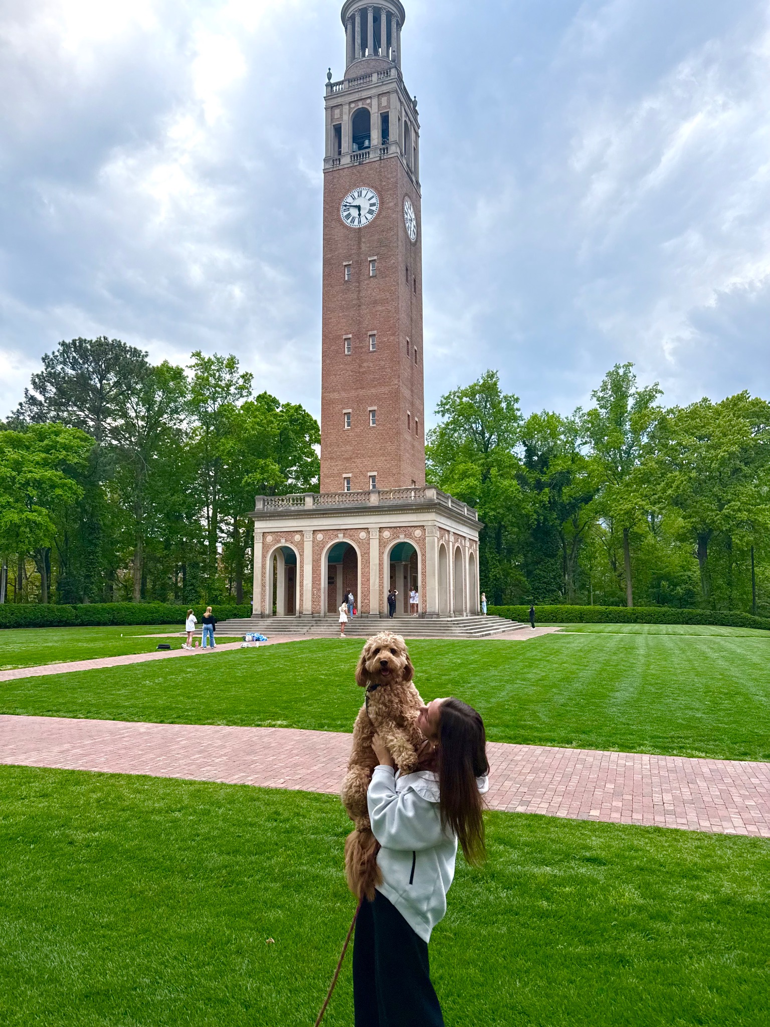 Caroline at UNC's Bell Tower with her dog Millie.