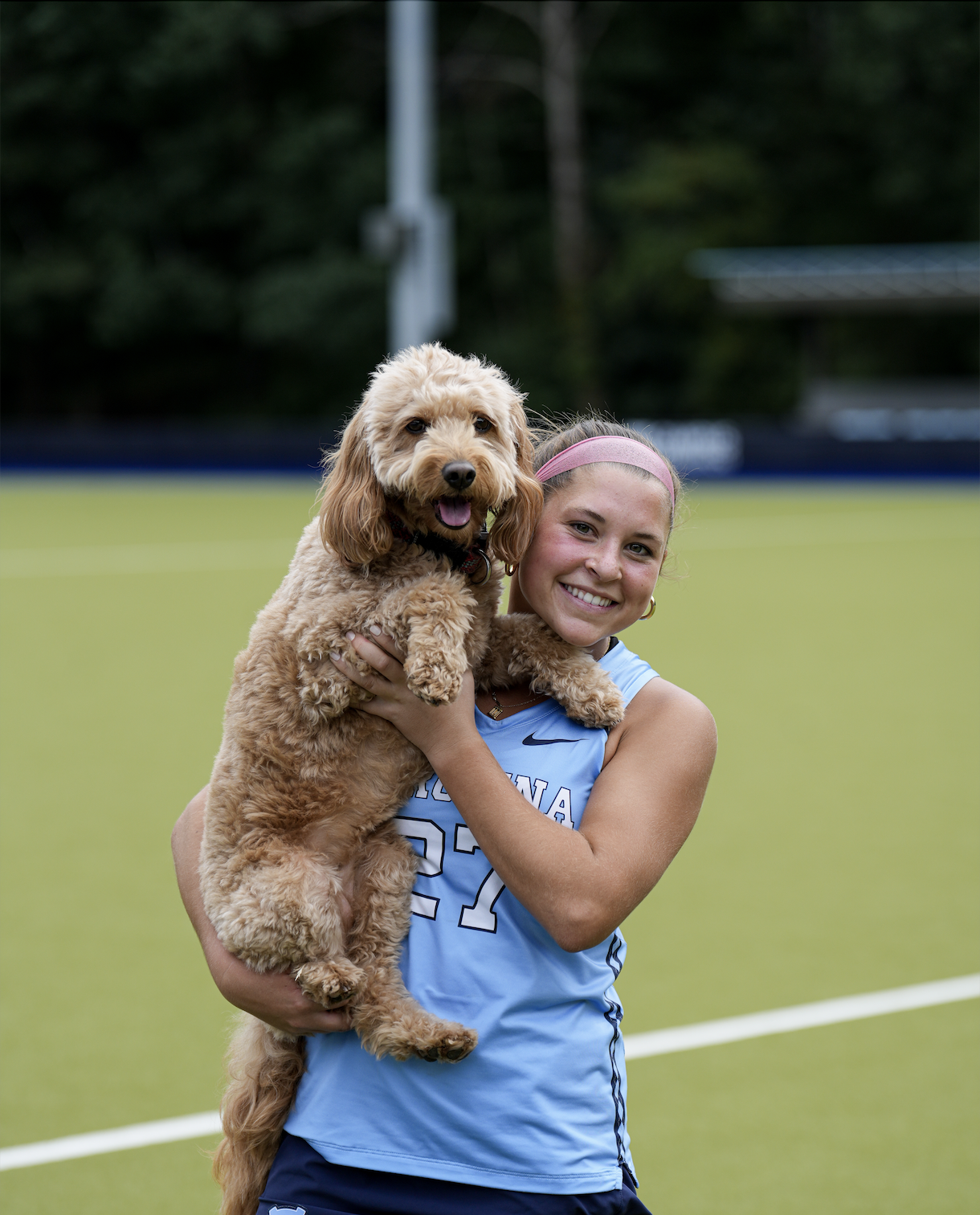 A picture of Caroline and her dog Millie at Karen Shelton Stadium